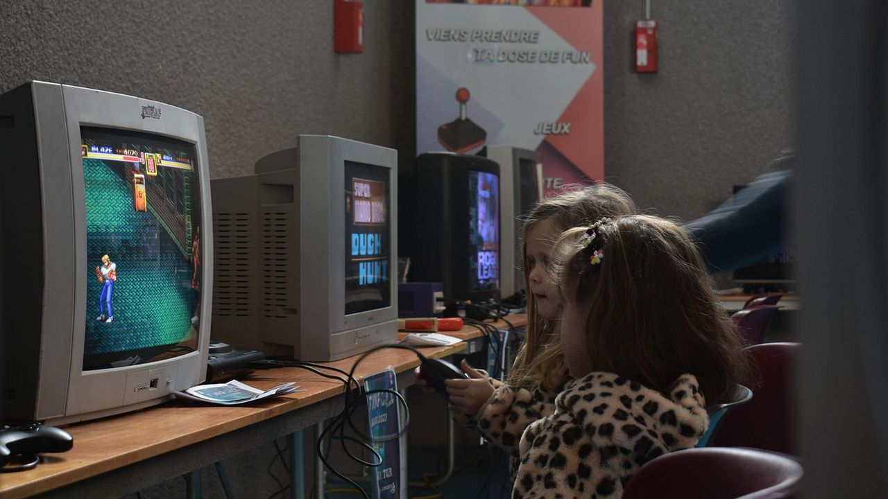 Child playing a video game on an old monitor