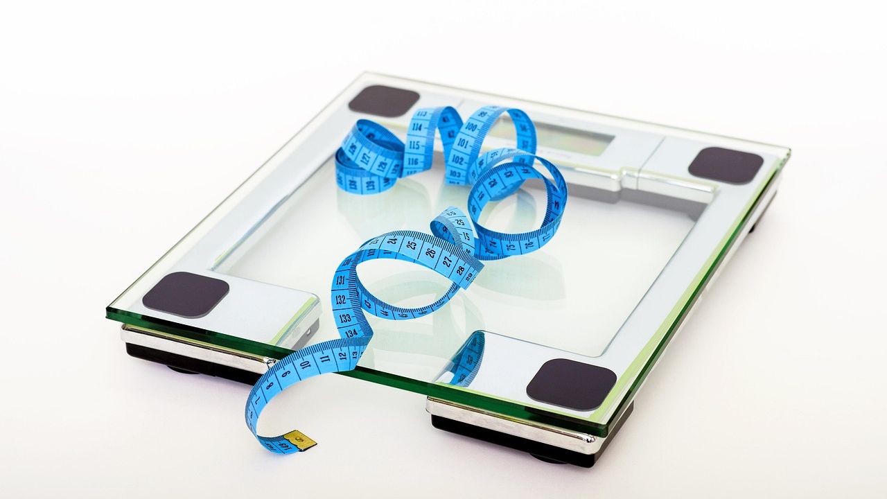 Glass bathroom scales with a tape measure