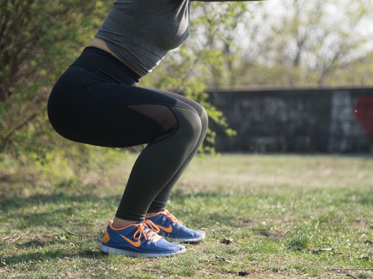 Woman doing a squat outdoors