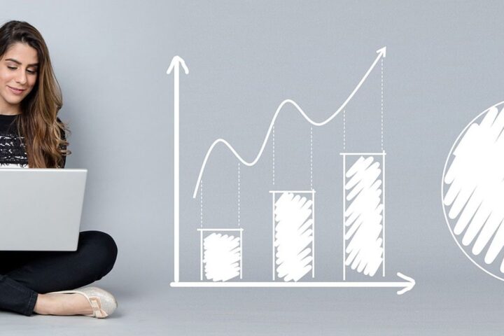 Woman with a laptop beside a sketched growth chart