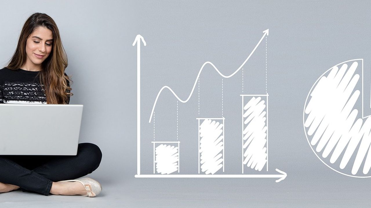 Woman with a laptop beside a sketched growth chart