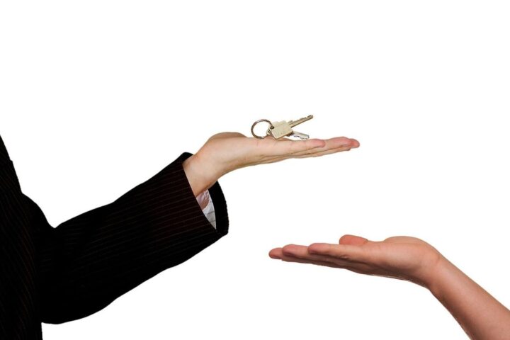 Estate agent handing house keys to a buyer