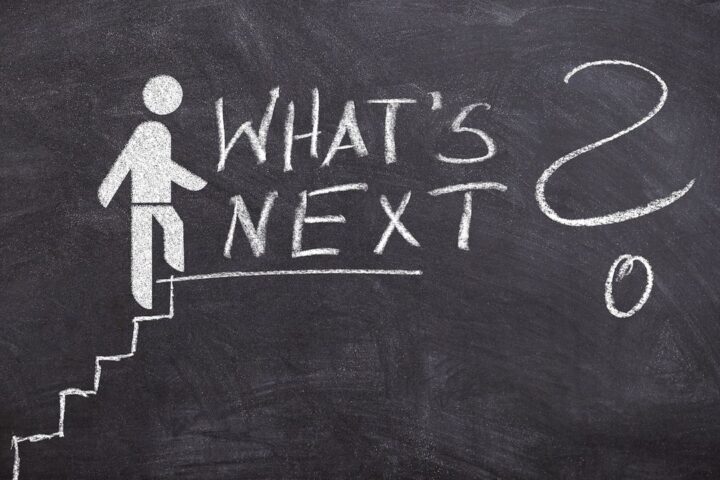 Chalk drawing of a figure climbing steps to the words What's next
